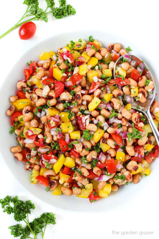 Vegan oil-free black-eyed pea salad in a white bowl with spoon
