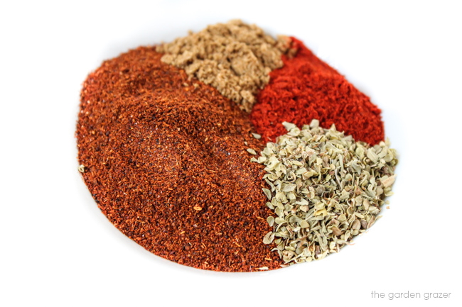 Seasonings in a bowl for chili spice blend such as chili powder, cumin, oregano, and smoked paprika