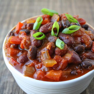 Vegan black bean chili in a bowl on a wooden table