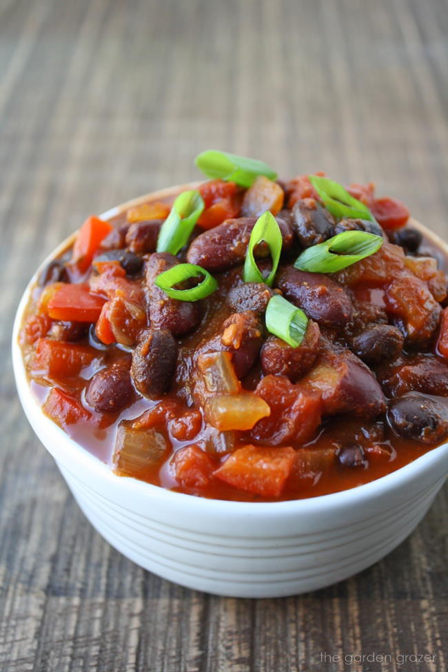 Vegan black bean chili in a bowl on a wooden table