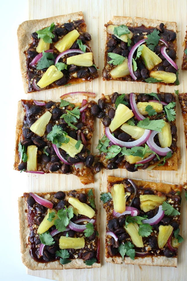Vegan Hawaiian BBQ pizza with black beans on a cutting board