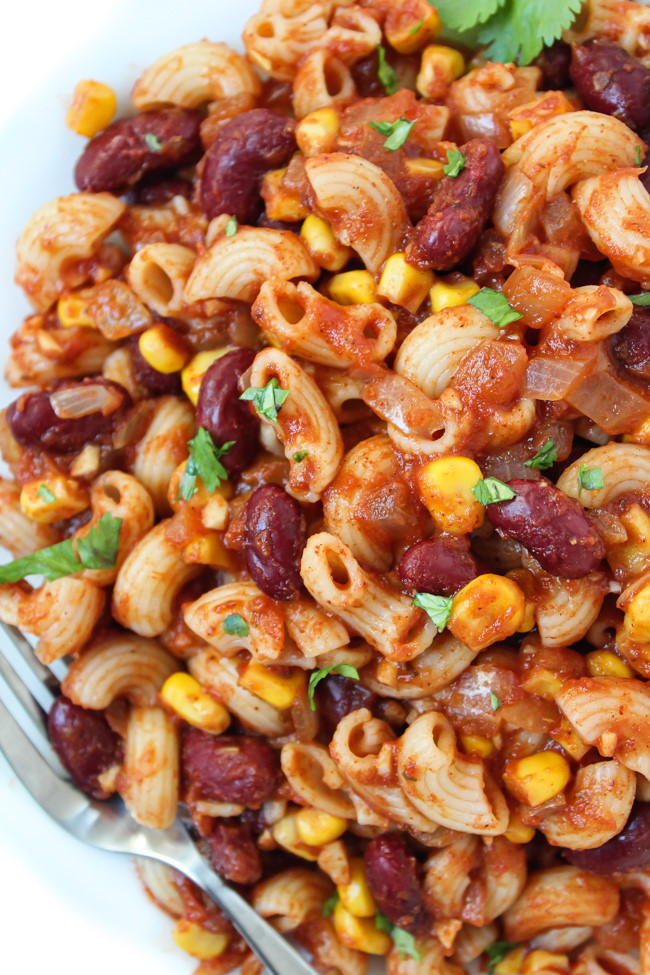 Vegan chili mac on a white plate with fork