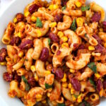 Overhead view of vegan chili mac on a white serving plate with fork
