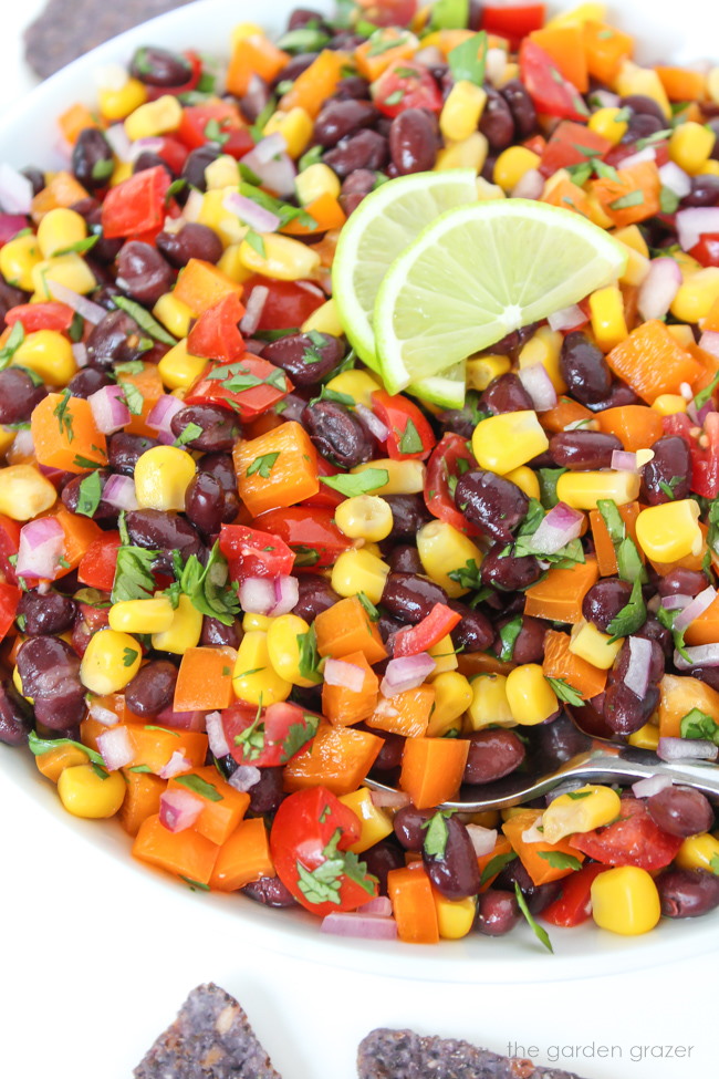 Bell peppers, tomatoes, and cilantro tossed together with sliced limes on top