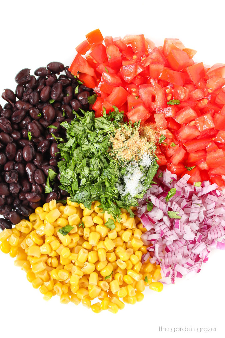 Overhead view of ingredients in a large glass bowl before mixing together