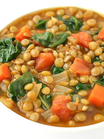 Lentil spinach soup in a white bowl