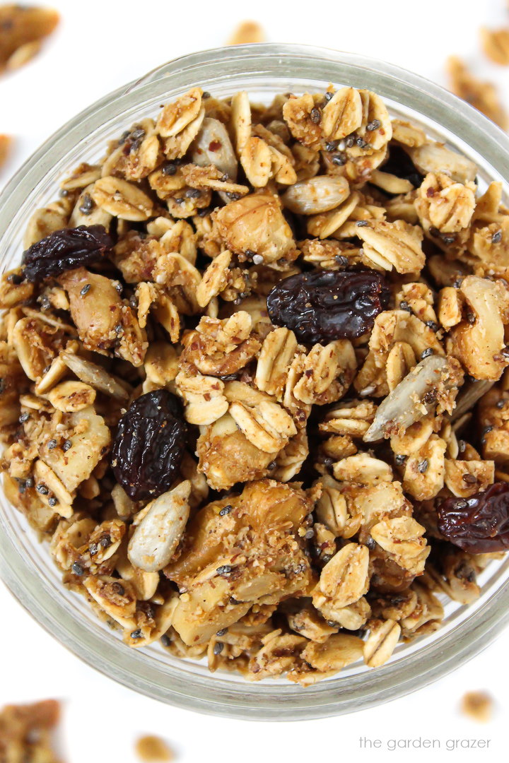 Overhead view of nut and seed granola in a small glass jar