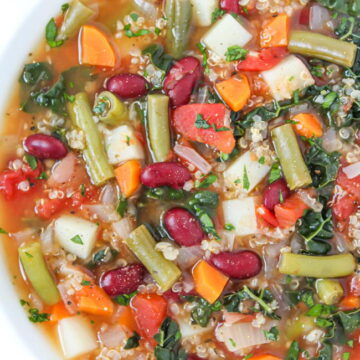 Vegan quinoa minestrone soup with kidney beans in a white bowl