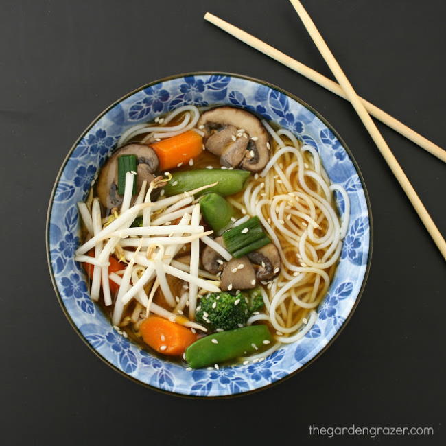 Asian style vegetable noodle soup in a bowl with chopsticks on the side