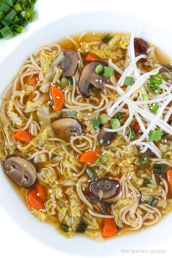Vegan Asian-inspired noodle soup in a white bowl
