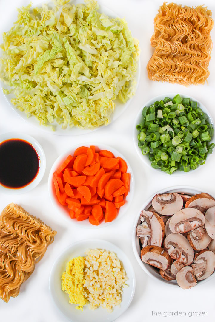 Fresh ingredients for soup laid out on a white table