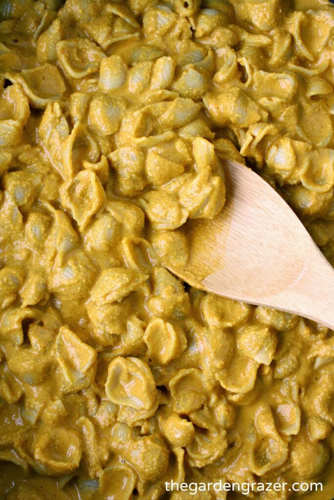 Cooked vegan mac and cheese with wooden spoon
