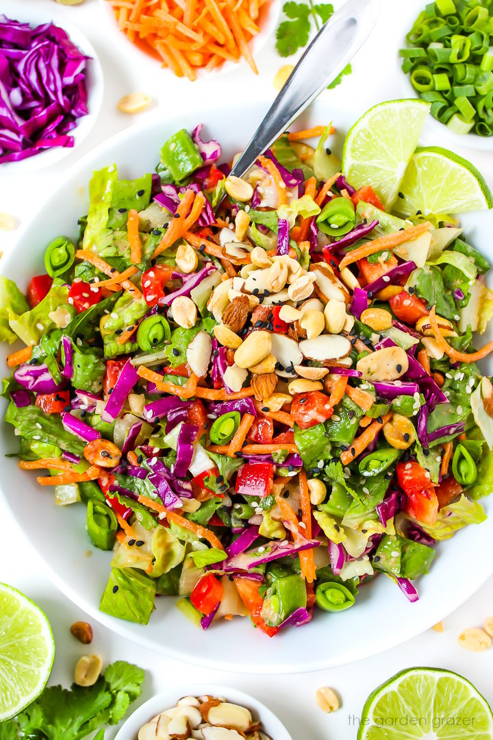 Asian Chopped Salad with sesame dressing in a white bowl with lime slices