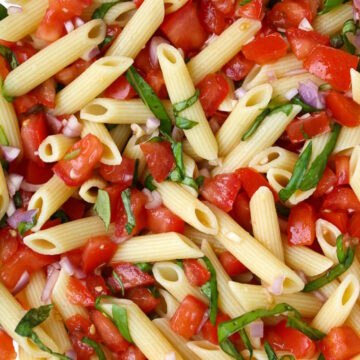 Close up view of fresh tomato basil pasta with lemon and garlic