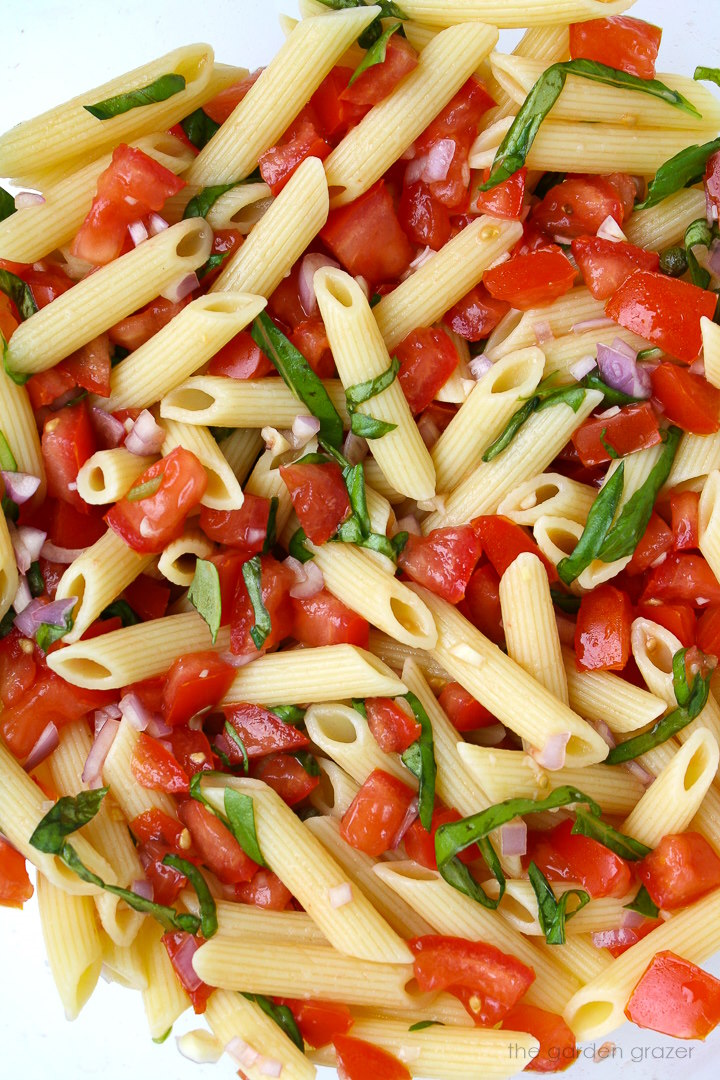 Close up view of fresh tomato basil pasta with lemon and garlic