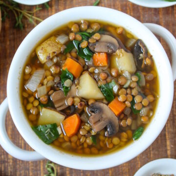 Rustic lentil potato soup in a white bowl on a wooden table