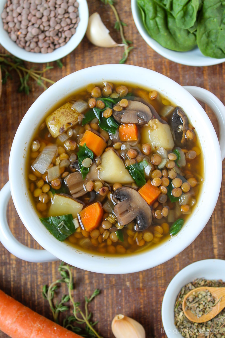 Rustic lentil potato soup in a white bowl on a wooden table