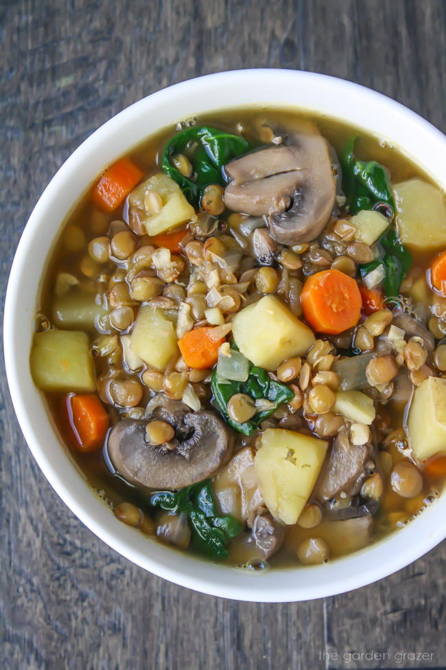 Bowl of lentil soup with potato, mushroom, and carrot