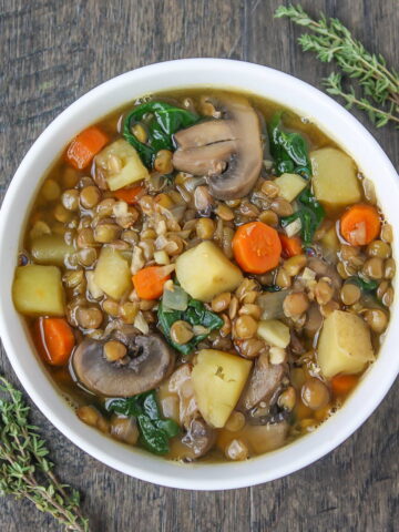 Lentil mushroom potato soup in a small white bowl