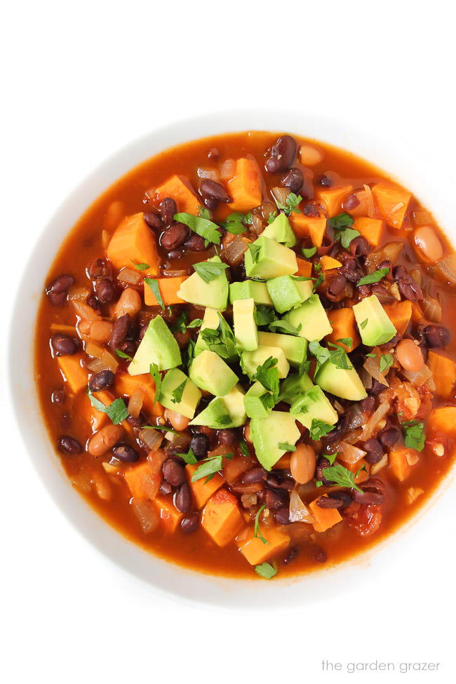 Overhead view of black bean chili in a bowl with avocado