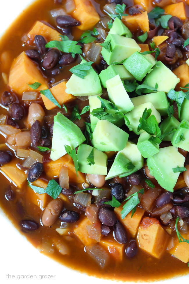 Bowl of vegan sweet potato chili with avocado
