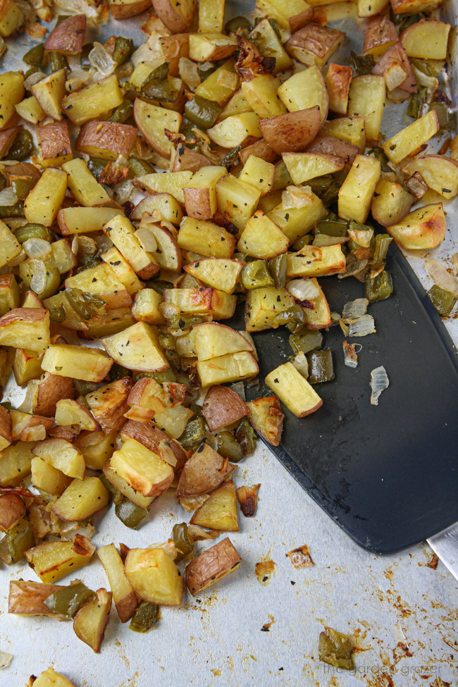 Baked homestyle potatoes on a sheet pan with spatula