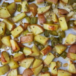 Sheet pan of oven roasted breakfast potatoes with onion and bell pepper