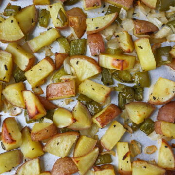 Sheet pan of oven roasted breakfast potatoes with onion and bell pepper