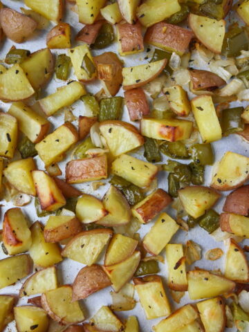 Sheet pan of oven roasted breakfast potatoes with onion and bell pepper