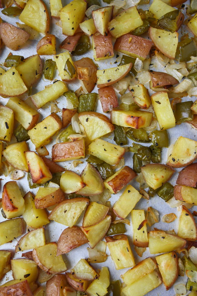 Sheet pan of oven roasted breakfast potatoes with onion and bell pepper
