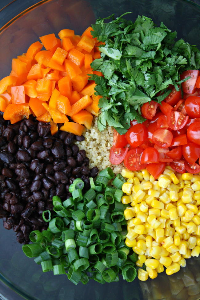 Fresh chopped ingredients arranged in a large glass bowl