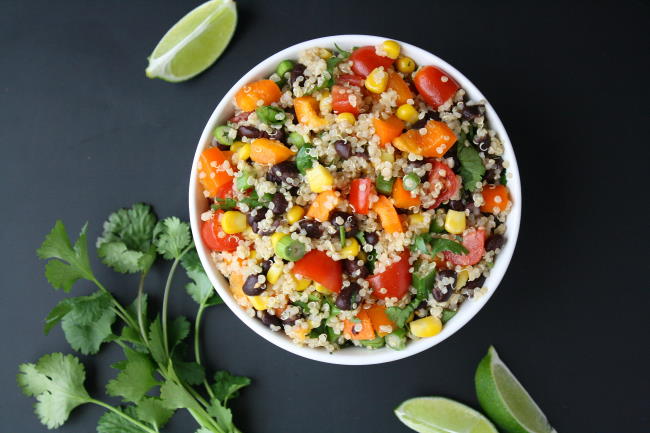 Vegan Mexican-inspired quinoa salad in a bowl with cilantro and lime