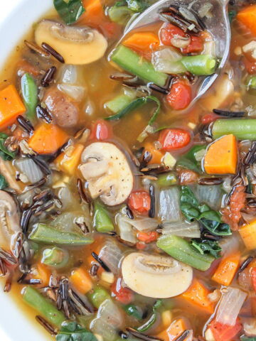 Wild rice veggie soup in a white bowl