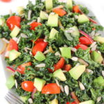 Marinated kale salad with avocado, tomato, onion