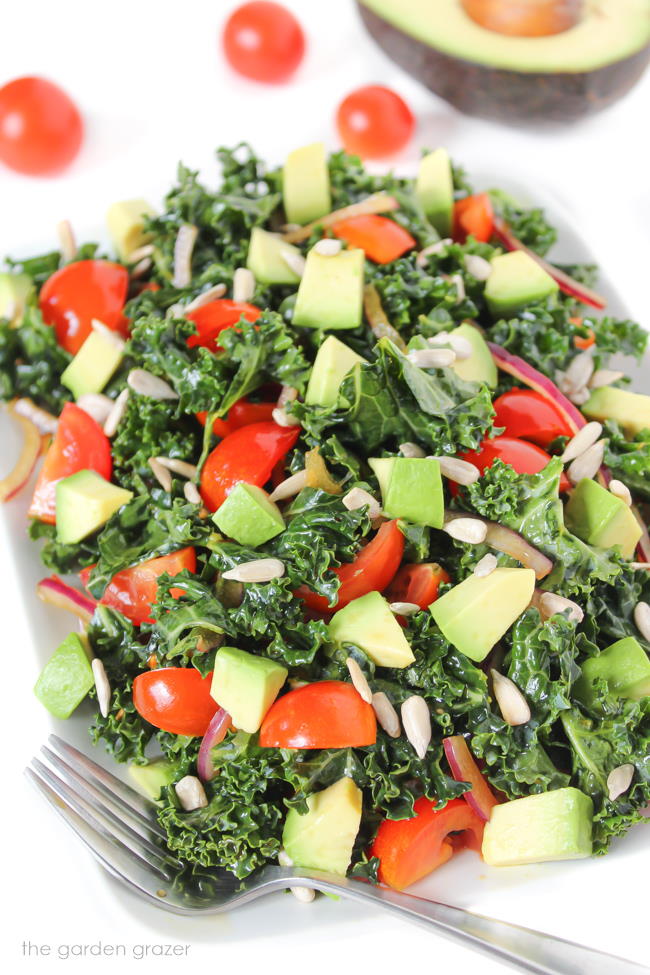 Marinated kale salad with avocado, tomato, onion