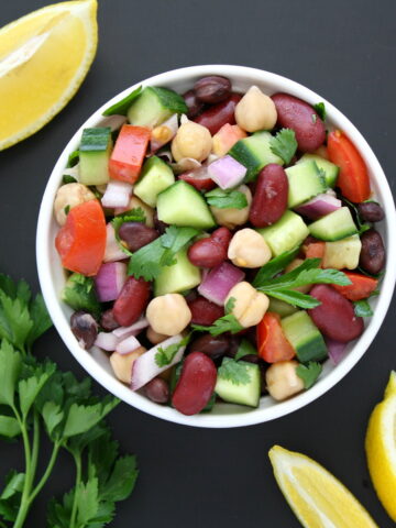Vegan Mediterranean bean salad in a small white bowl