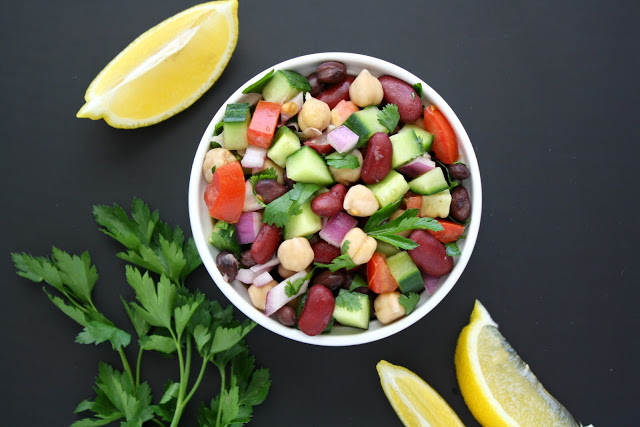 Bowl of Mediterranean salad with beans, herbs, and lemon