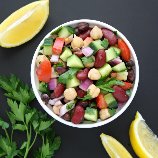 Bowl of Mediterranean three salad with beans, herbs, and lemon