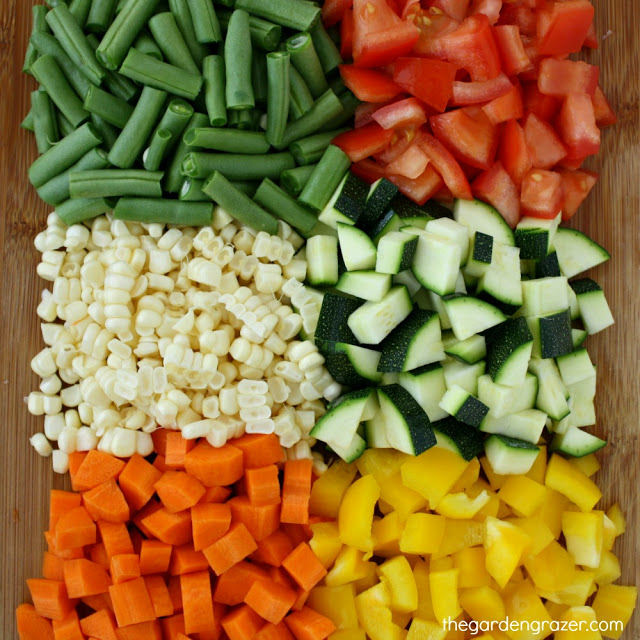 Raw vegetables diced on a cutting board ready for soup