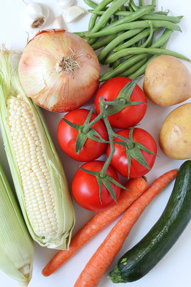 Fresh summer vegetables on a white table