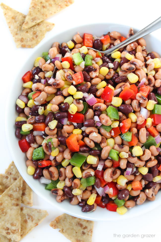 Texas Caviar in a large bowl with spoon and chips