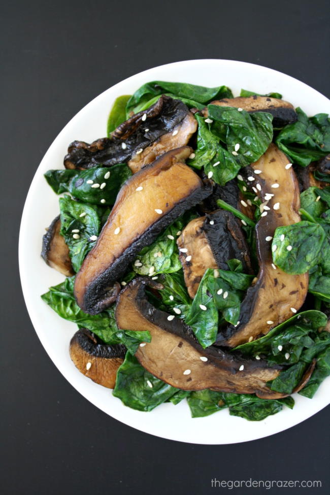 Sautéed mushrooms and greens on a white plate