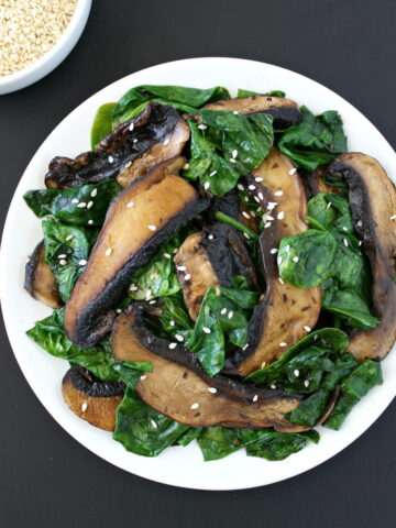 Portobello mushroom with spinach on a white plate