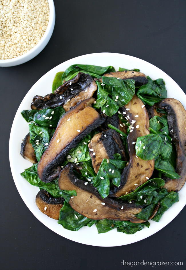 Portobello with spinach topped with sesame seeds on a plate