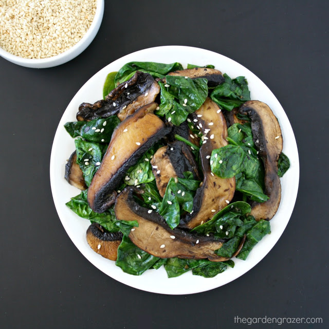 Plate of cooked portobello mushrooms with spinach