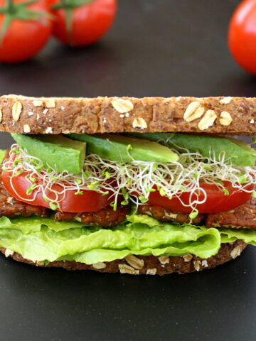 Vegan BLT sandwich on a black table