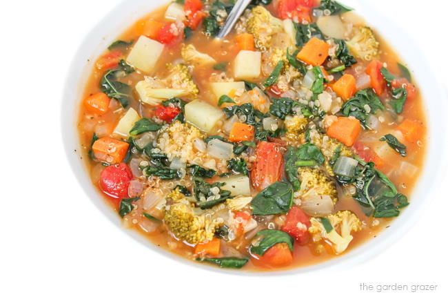 Bowl of quinoa potato soup with kale, spinach, broccoli