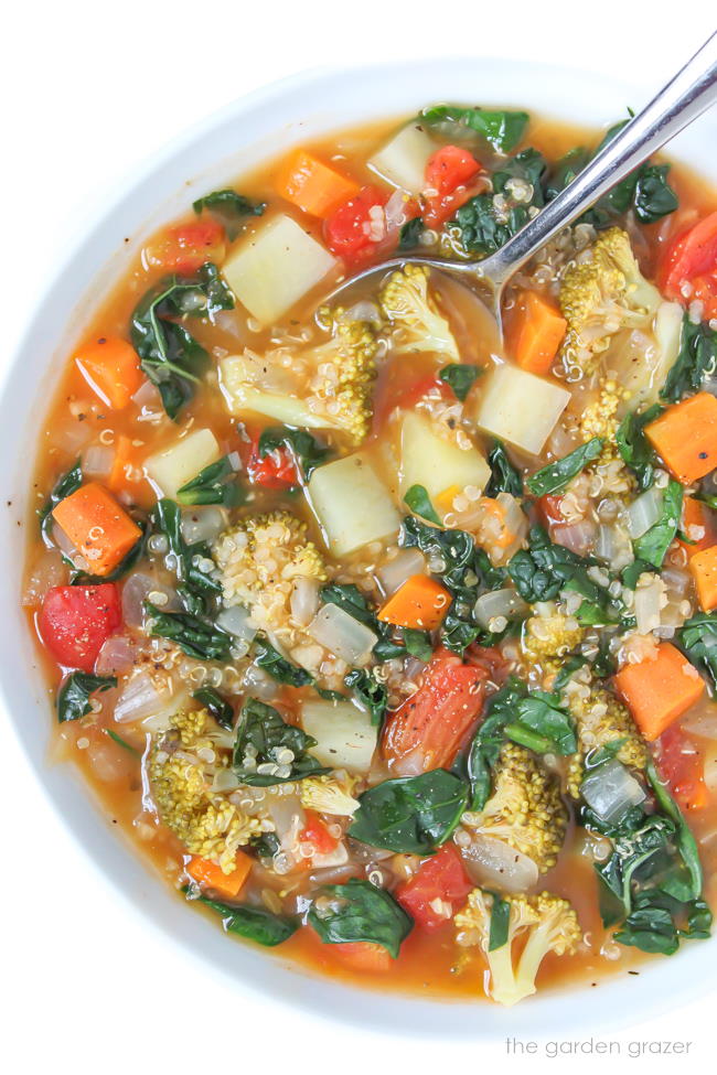 vegan quinoa potato soup in a bowl with spoon