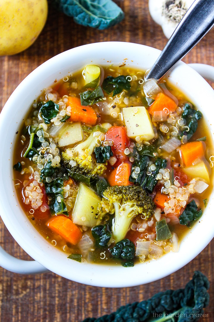 Close up view of quinoa potato soup with kale, spinach, and broccoli