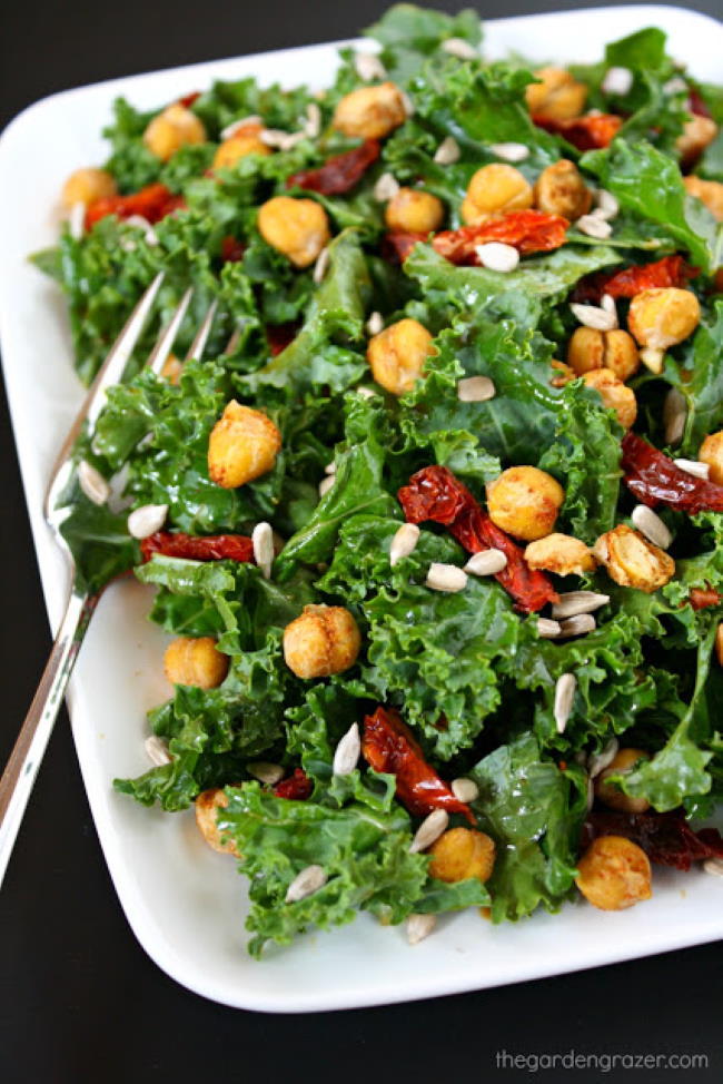 Kale salad with roasted chickpeas on a plate with fork